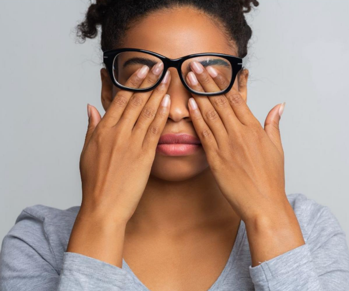 A woman rubbing her eyes and needing behavioural optometry assessment